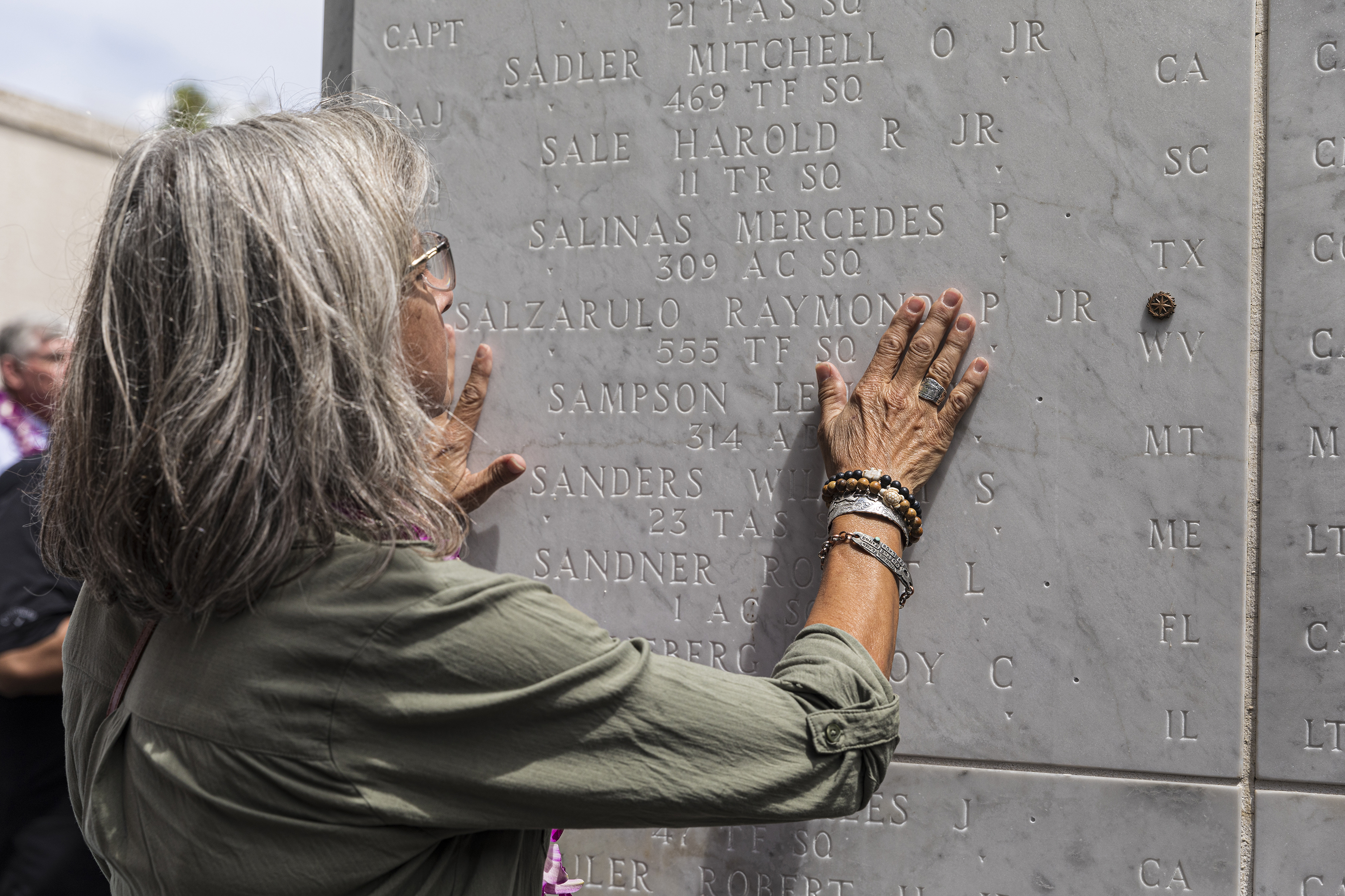 Picture of bronze rosette being placed by Suzanne Sylvester at the Honolulu Memorial. Credits: American Battle Monuments Commission