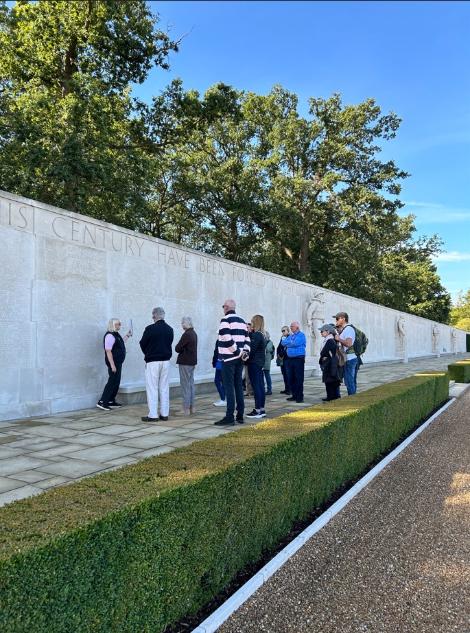 Visitors in front of the wall of the missing at Cambridge American Cemetery during a tour. Credits: American Battle Monuments Commission.