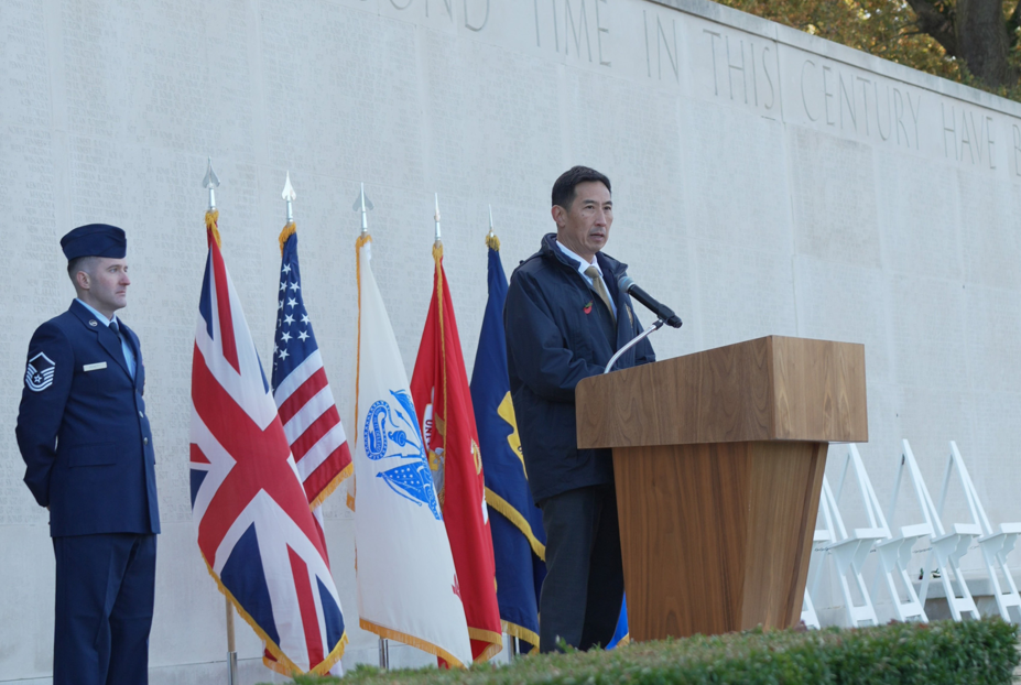 ABMC secretary Charles K. Djou delivering remarks at Cambridge American Cemetery for Veterans Day. Credits: American Battle Monuments Commission