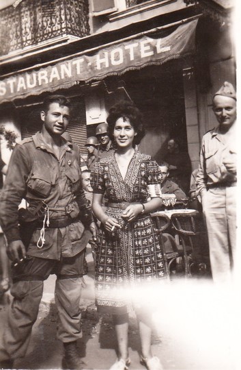 Corporal Burl J. Knapp, 509th Parachute Infantry Battalion (left) standing next to Nicole Celebonovitch, a member of the French Resistance. 