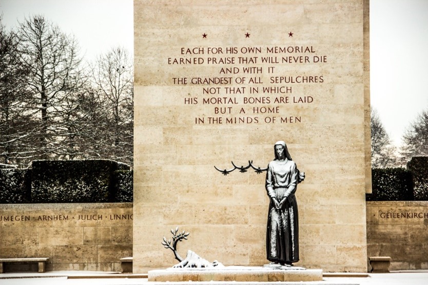 The statue of the Mourning Woman under the snow at Netherlands American Cemetery. Credits: American Battle Monuments Commission 