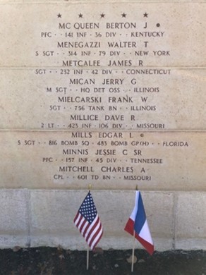 A bronze rosette placed near SSgt. Edgar Mills’ name on the Wall of the Missing at Epinal American Cemetery in France to indicate he has been accounted for. Credits: ABMC
