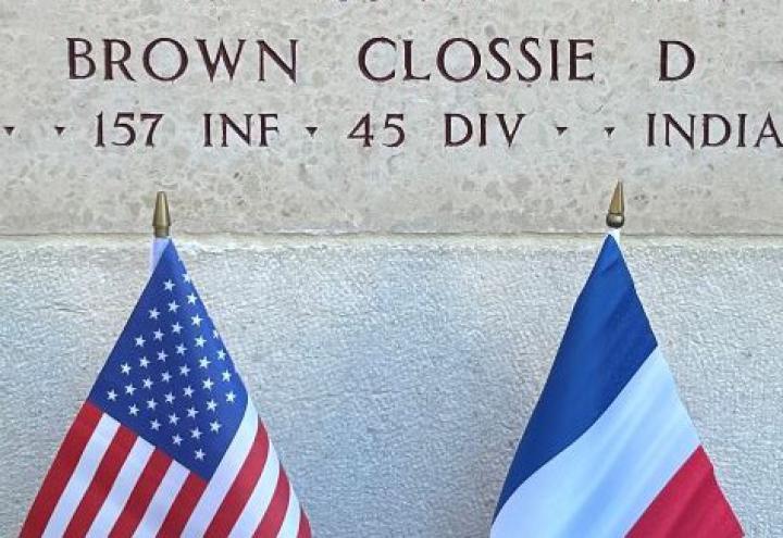 A bronze rosette is placed next to the name of Pfc. Clossie D. Brown at Epinal American Cemetery