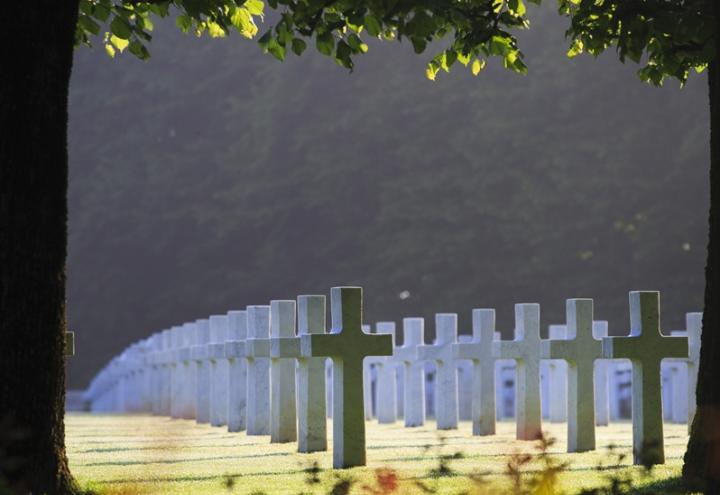 White marble headstones stand perfectly aligned at St. Mihiel American Cemetery