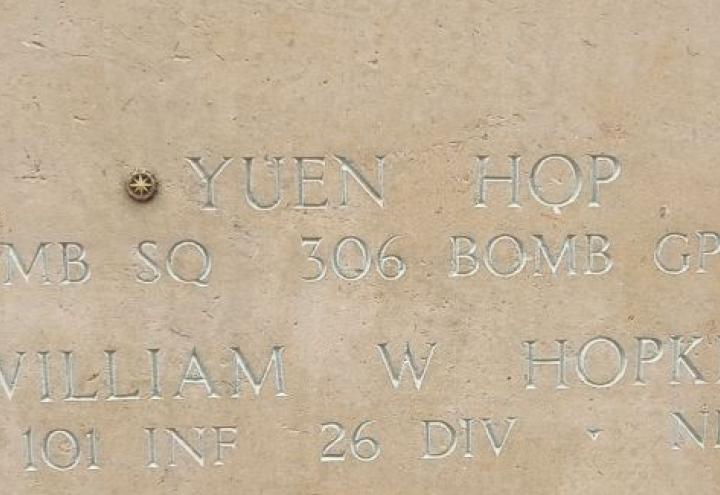 A bronze rosette is placed next to the name of Yuen Hop