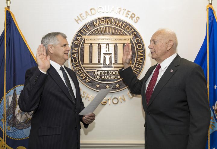 Dalessandro and Matz face each other with a hand raised as the oath is recited. 