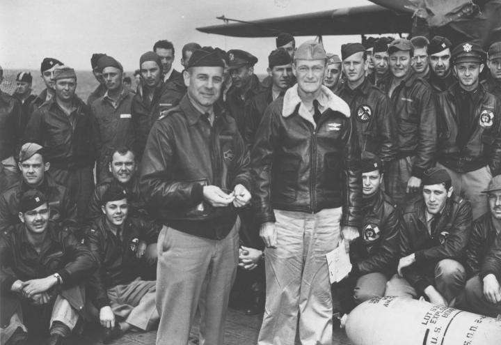 Doolittle, Mitscher, and many other service members stand on deck in historic photo. 