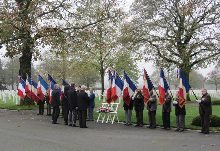 Flag bearers flank the wreath as town officials present it during the ceremony. 