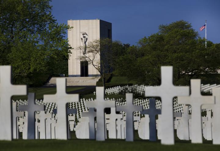 Marble headstones fill the landscape in front of the chapel at Lorraine American Cemetery. 