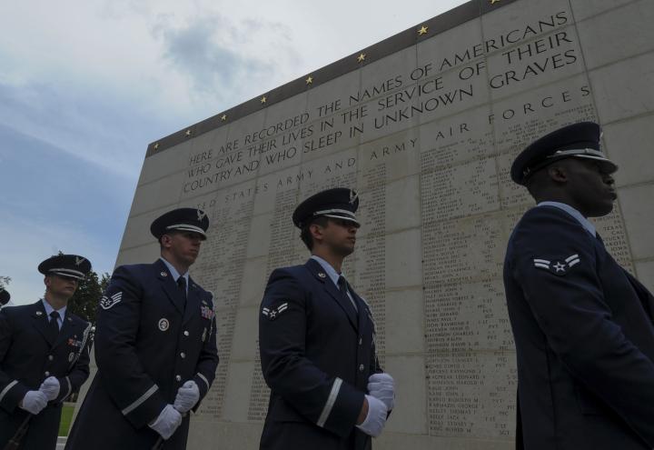 Members of the Air Force stand in front of the Wall of the Missing. 