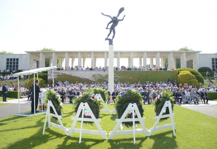 A large crowd sits during the ceremony as they listen to remarks. 