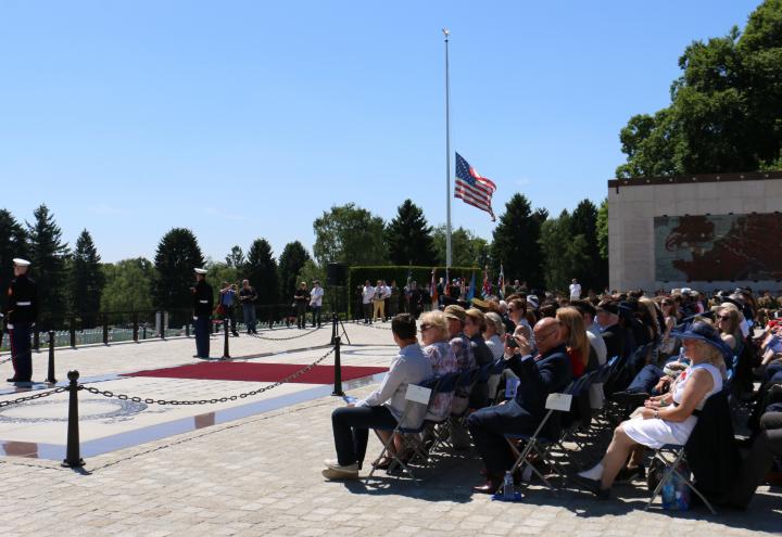 Attendees sit in chairs during the ceremony.