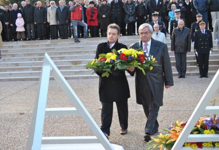 Ceremony participants prepare to lay a floral wreath during the ceremony. 