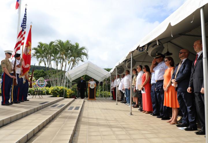 Attendees stand at the beginning of the ceremony. 