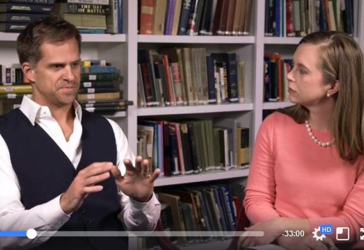 Hamner and Herrmann sit in front of bookshelves during the discussion.