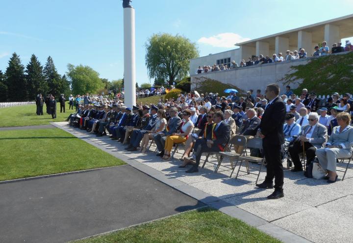 Attendees sit in chairs during the ceremony.