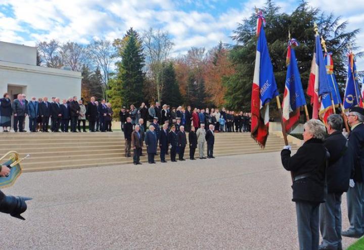 Attendees stand on the steps outside the memorial building. 