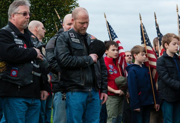 Members of the American Legion Riders stand with their hands over their hearts during the ceremony. 