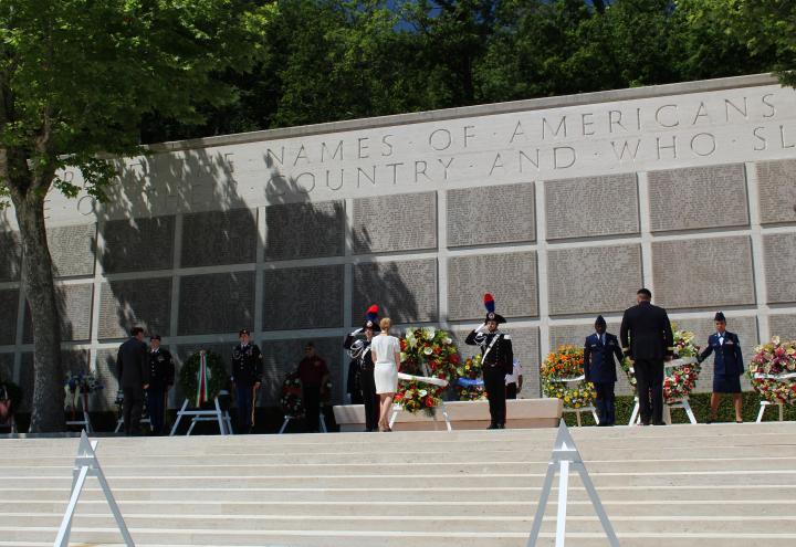 Men in uniform salute after the wreath is laid.