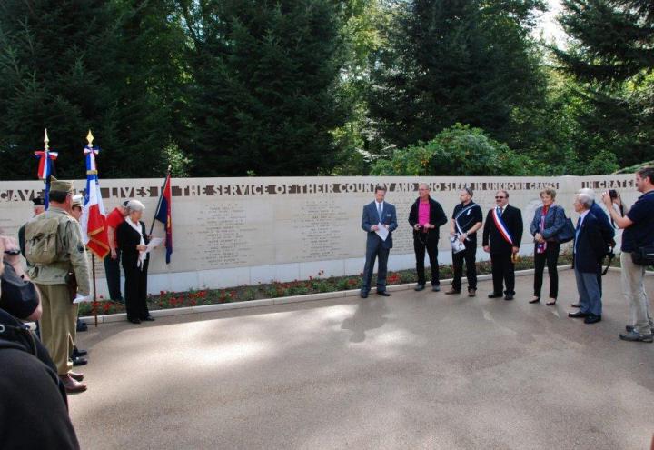 Attendees stand at the Wall of the Missing. 