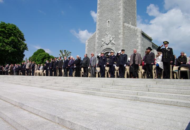 Ceremony attendees stand in front of chapel.