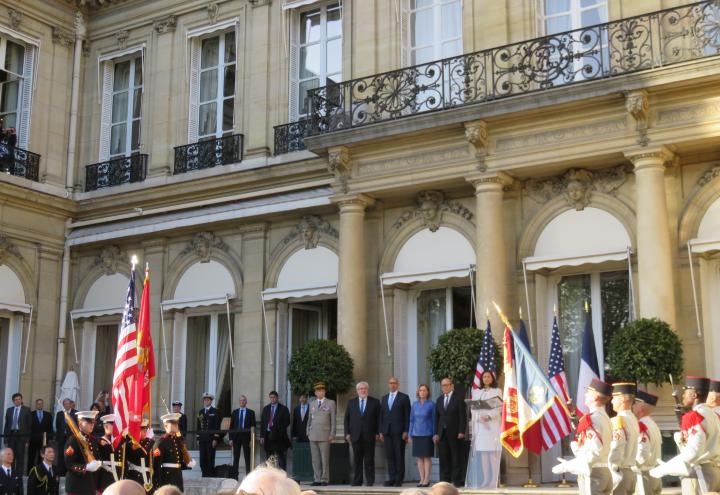 Members of the official stand in front of the crowd during the ceremony. 