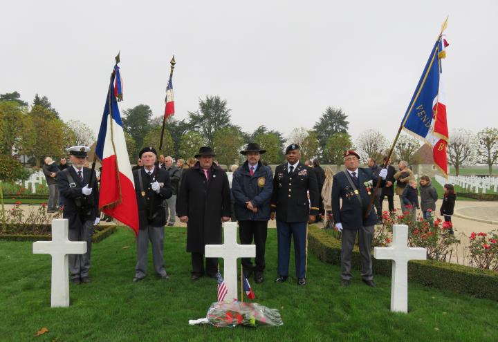 The flag bearers stand with the mayor and two other officials after the flowers have been laid. 