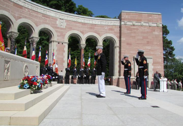 Marines salute after laying wreaths.