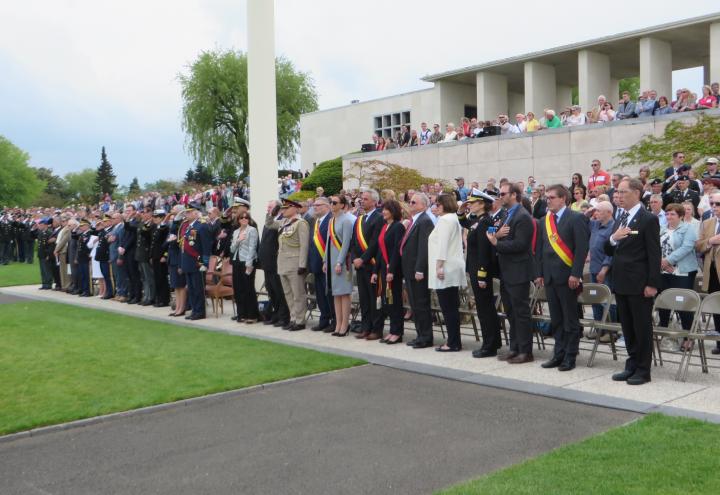 Members of the crowd stand during the ceremony. 