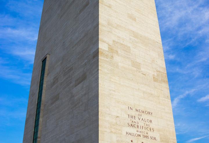 A tall brick building houses the chapel at Netherlands American Cemetery