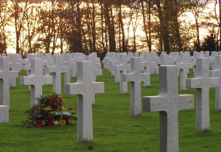 Flowers rest at a headstone at St. Mihiel American Cemetery. 