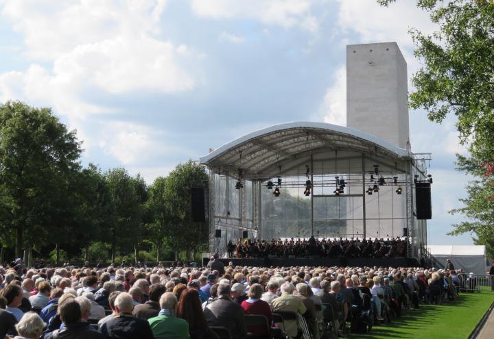 Attendees sit in chairs during the performance. 