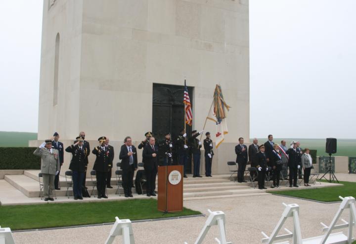 Ceremony participants stand in front of the chapel building. 