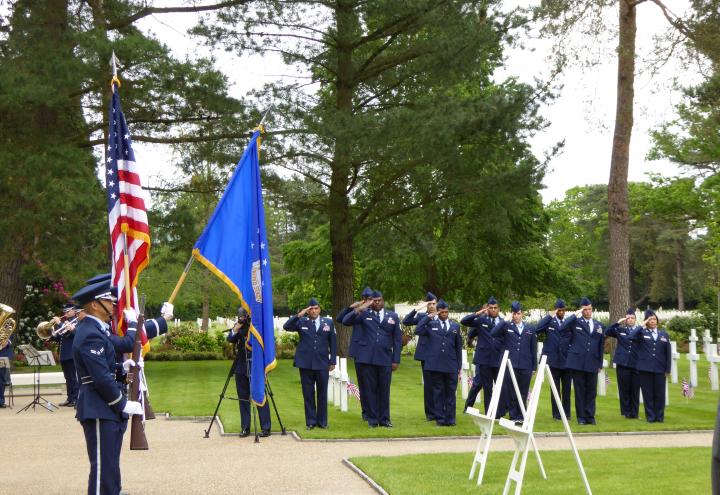 Airmen salute while the Color Guard posts the colors.