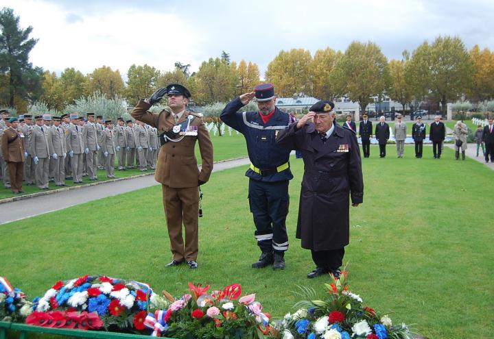 Ceremony participants salute wreaths after they are laid. 