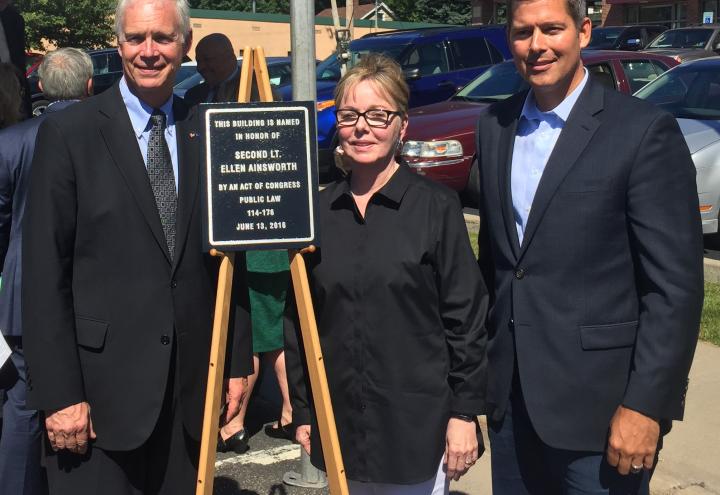 Senator Ron Johnson, Sally Berkholder, and Congressman Sean Duffy stand next to the plaque. 