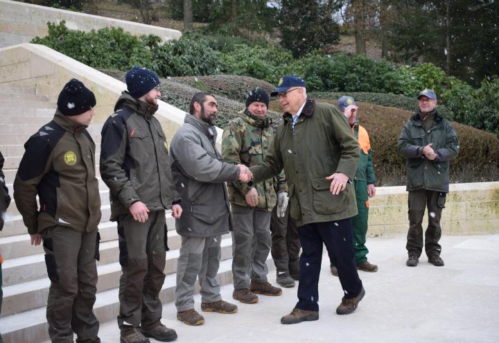 Secretary Matz shakes hands with a man amidst snow fall. 