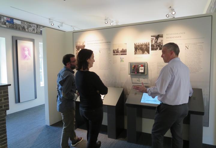 Superintendent Chris Arseneault explains one of the new exhibit panels. 