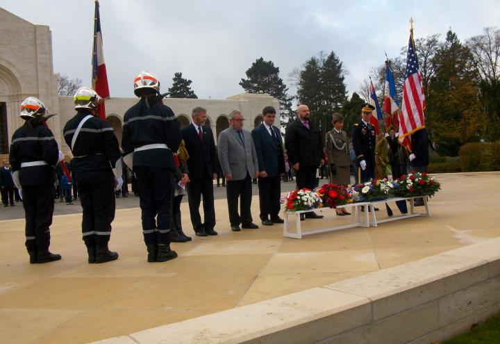 Members of the official party pause after laying their floral wreaths. 