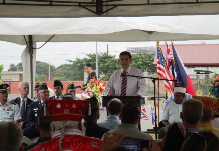 A man delivers remarks from a podium. 