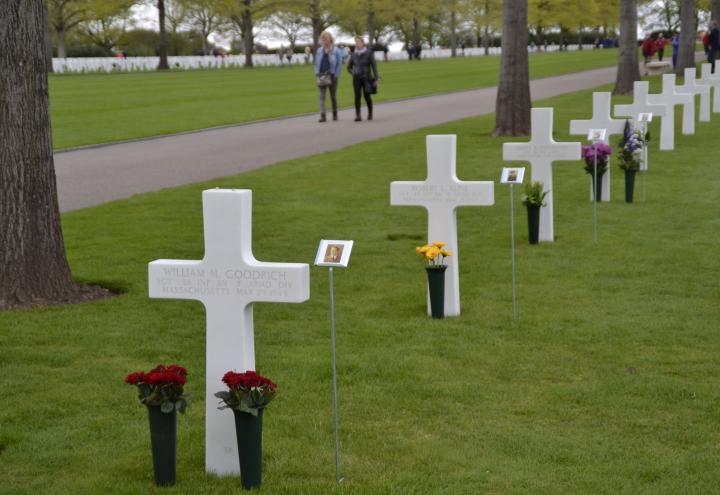 Headstones decorated with flowers and photos. 