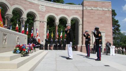 Marines salute after laying wreaths.
