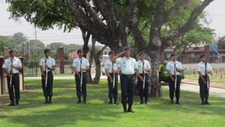 Men in uniform hold a firearm. 