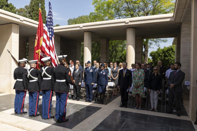 Attendees stand at the beginning of the ceremony. 