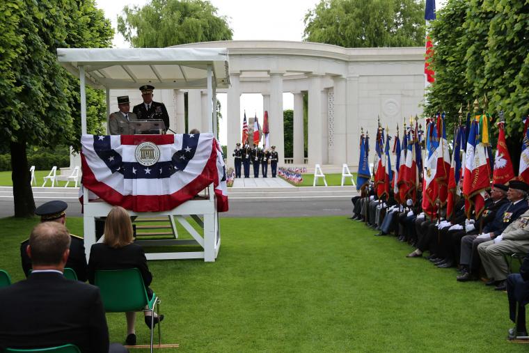 A man in uniform delivers remarks from the podium during the ceremony. 