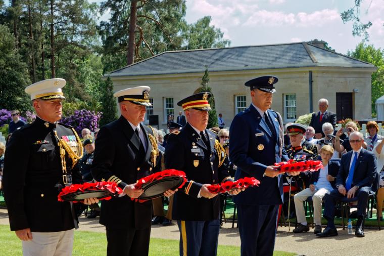 Men in uniform prepare to lay wreaths during the ceremony. 