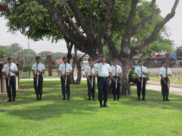 Men in uniform hold a firearm. 