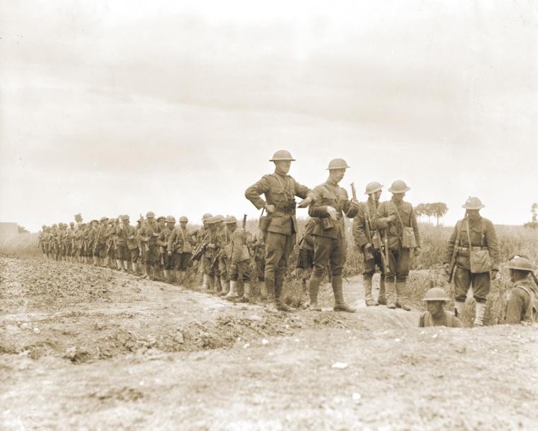 Soldiers of the 119th Infantry, 30th Division, entering trenches, July 9, 1918.