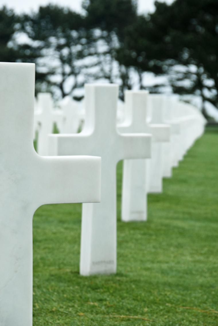 White headstones in a row at Normandy American Cemetery.