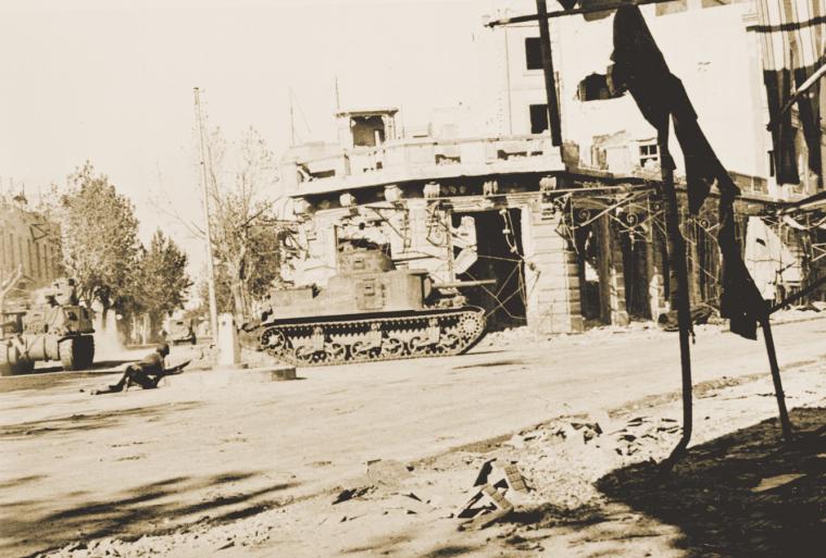 U.S. infantry and tanks clear Bizerte of enemy snipers.